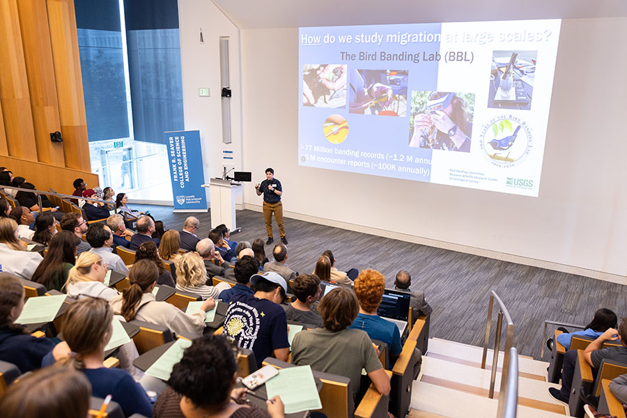 Wide shot of presenter in audience
